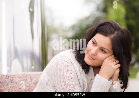 Beautiful young woman in her thoughts. Shallow depth of field. Stock Photo