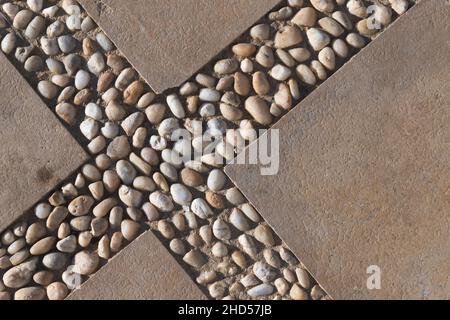 Decorative flooring with concrete blocks and pebble, top view Stock Photo