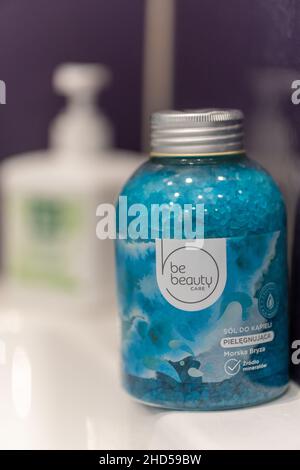 Vertical shot of Be Beauty brand blue bathing salt in a plastic bottle Stock Photo