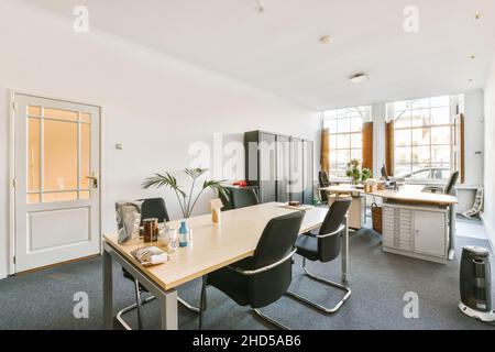 Workplaces in a bright, modern room. The room with modern computers and bookshelves Stock Photo
