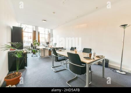 Workplaces in a bright, modern room. The office with modern computers and bookshelves Stock Photo