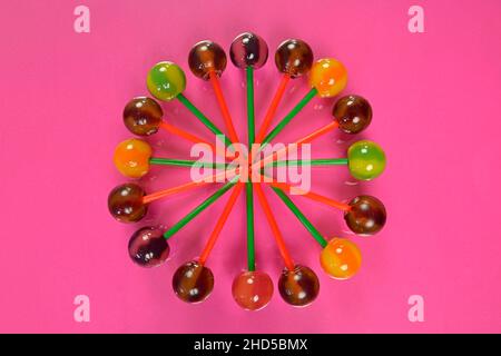 Mix of colorful lollipops. Children lollipops on a pastel background. Copy space, flat lay. Lollipops on a pink background. Stock Photo