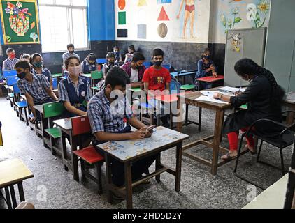 Mumbai, India. 03rd Jan, 2022. Students are seen sitting inside a classroom during a vaccination drive at Sainath school in Navi Mumbai.Vaccination for children in the age group of 15-18 years of age was launched in India. Credit: SOPA Images Limited/Alamy Live News Stock Photo