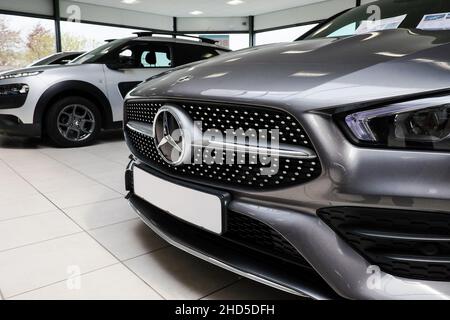 Various brands and types of cars prepared for sale in a showroom Stock Photo