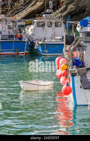 Fishing boats moored in the historic picturesque working Newquay Harbour in Newquay on the North Cornwall coast. Stock Photo