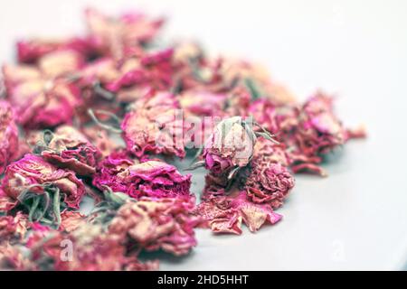 Dry rose buds tea on white background. Selektive focus. Stock Photo