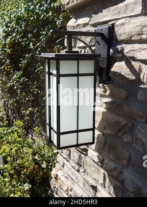 Decorative outdoor craftsman style lantern on stone pillar Stock Photo