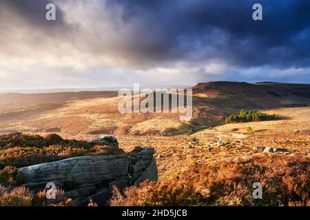 Warm light on the landscape of Higger Tor and Carl Wark. Stock Photo