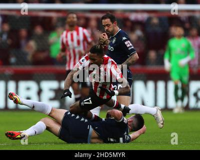 BRENTFORD, ENGLAND - JANUARY 02: Ivan Toney of Brentford is tackled by Josh McGinn of Aston Villa during the Premier League match between Brentford and Aston Villa at Brentford Community Stadium on January 2, 2022 in Brentford, England. (Photo by Ben Peters/MB Media) Stock Photo