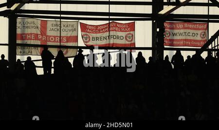 BRENTFORD, ENGLAND - JANUARY 02: A general view of silhouetted Brentford fans and flags during the Premier League match between Brentford and Aston Villa at Brentford Community Stadium on January 2, 2022 in Brentford, England. (Photo by Ben Peters/MB Media)