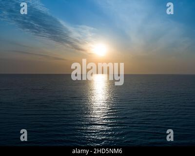 Beautiful sunset over the sea horizon and cloudy sky Stock Photo