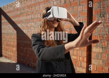 Female using augmented reality glasses on building site Stock Photo
