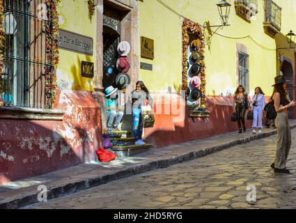 Street vendors hawk their wares on cobblestone streets to Shoppers and tourists in the centro district in the colonial city of San Miguel de Allende, Stock Photo