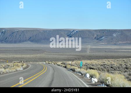 The approach to the dramatic steep cliffs of Sage Butte on the remote Adel-Denio road (OR-140, Warner Highway) in southern Oregon, United States. Stock Photo