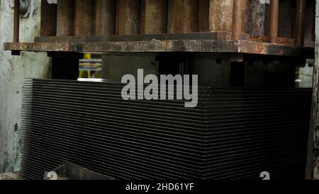 Automatic metal press machine during working process at a factory. Process of manufacturing metal part on a press machine., automatic stamping Stock Photo