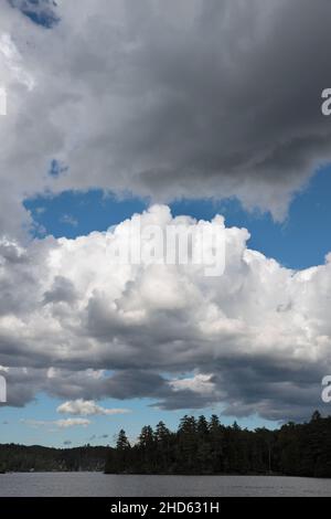 Dramatic picture perfect summer blue sky cloudscape background over Lake Paradox. Cumulus clouds on a summer day above the Adirondack Mountain wildern Stock Photo