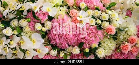 Various flowers background, panoramic top view of fresh orchids, roses and other flowers. Nice pastel pattern with beautiful flowers. Nature, wedding, Stock Photo