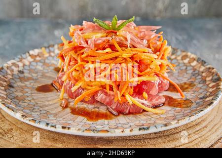 Carrot, apple, nut and pamela salad on plate. French gourmet food Stock Photo