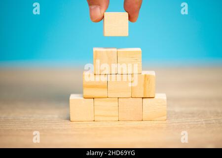 Hand holding a wooden block letter e, put on the meaning of the word change, business idea, change in new things, adjusting plans to succeed. Stock Photo