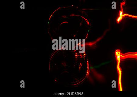 Top view of a shiny Black Orb of the Lensball Displays Red Streaks lights on a black background Stock Photo