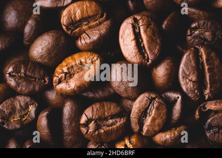 Roasted coffee beans full frame background Close up macro dark brown Stock Photo