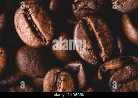 Roasted coffee beans full frame background Close up macro dark brown Stock Photo