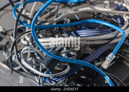 bundle of computer cables in mess, shallow DOF closeup Stock Photo