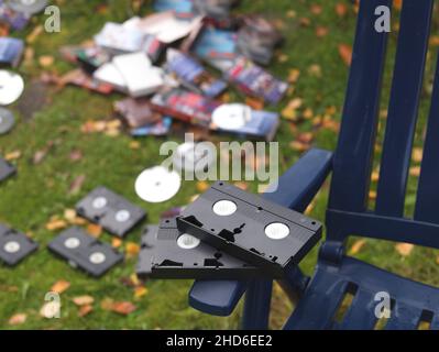 shallow dof shot of discarded video cassettes and compact discs outdoor Stock Photo