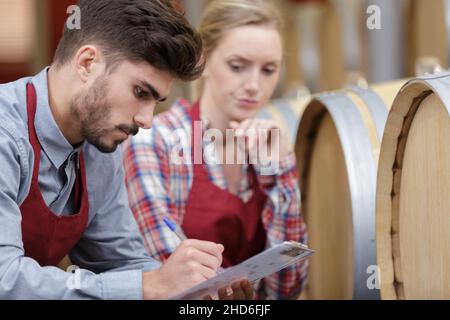 two cellar colleagues with clipboard Stock Photo