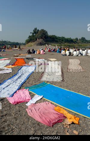 Religious ritual place on the shore of two river meet river Bhima and Nira people drying their cloths on a sand Stock Photo