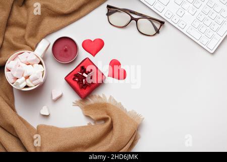 Desktop. Scarf glasses keyboard marshmallows valentine's day gift on gray table. Flat lay copy space Stock Photo