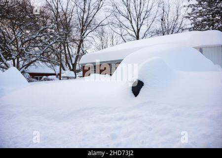 Mailboxes, located along a neighborhood road are covered in snow after a winter blizzard. Stock Photo