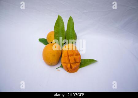 Fresh Delicious Slice Yellow Ripe Mango with Green leaf on isolated Background Stock Photo