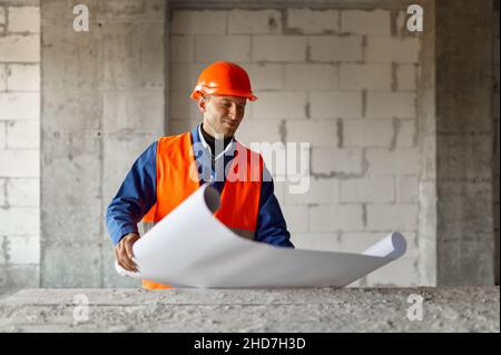 Male engineer builder with paper blueprint draft Stock Photo