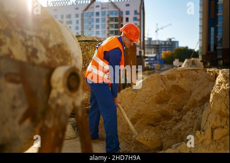 Male worker making concrete at construction site Stock Photo
