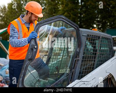 Construction worker in vehicle cab closeup shot Stock Photo