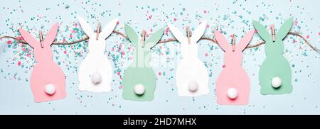 Easter banner with diy paper rabbits garland and sweet easter eggs Stock Photo