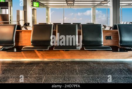 Row of empty waiting seats in the departure lounge of airport. Travel and business concept. Stock Photo