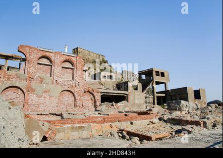 Derelict concrete buildings on the abandoned island of Hashima or Gunkanjima or Battleship Island, near Nagasaki Japan Stock Photo