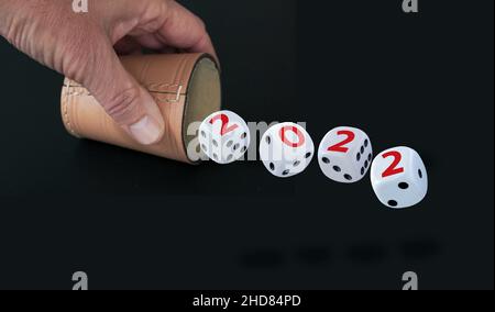 White dices with black eyes and numbers spelling 2022 in red letters. Image isolated on white background. Year 2022 concept. Stock Photo