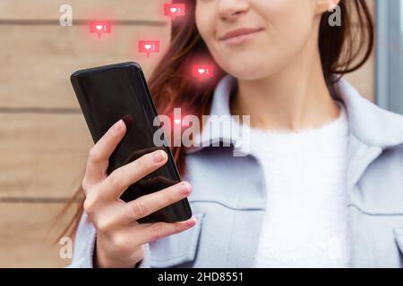 Likes from phone screen. Attractive young woman. Stock Photo