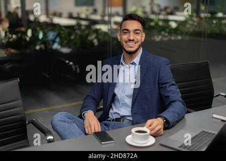 Handsome arabic businessman sitting at conference hall Stock Photo