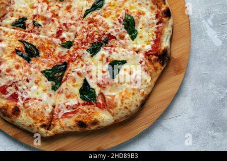 Whole neapolitan pizza served on wooden board. Stock Photo