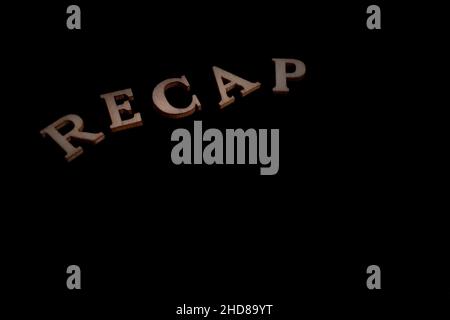 RECAP word made of wooden  letters isolated on black background - copy space Stock Photo