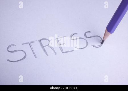 pastel pencil to write the word stress om white paper Stock Photo