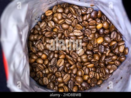 Coffee beans in a standing bag, vertical from above, selective focus Stock Photo