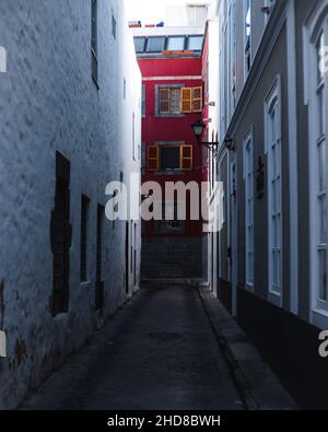 Red house at the end of a street Stock Photo