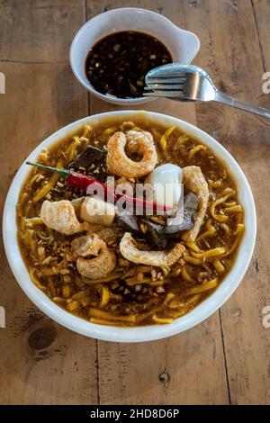 Sumptous Batangas Lomi in a bowl served hot full of toppings Stock Photo