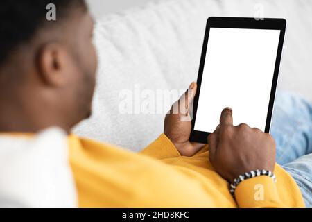 Modern digital tablet with blank screen in black guy hands Stock Photo