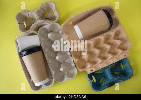 Eco-friendly food containers made of paper on a yellow background. Without plastic. Top view. Stock Photo